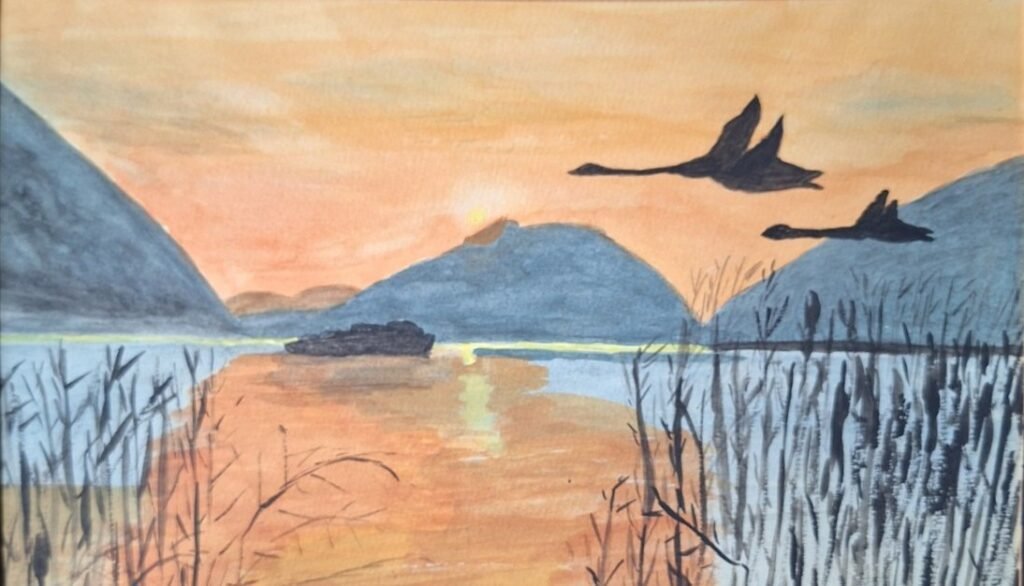 Geese flying over an orange sunset with mountains in the distance and reeds in the foreground
